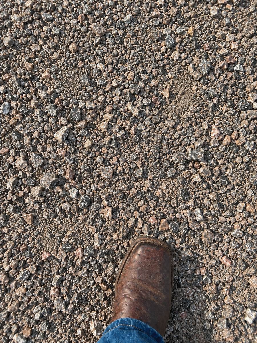 Quarter-inch crushed granite with a work boot for scale